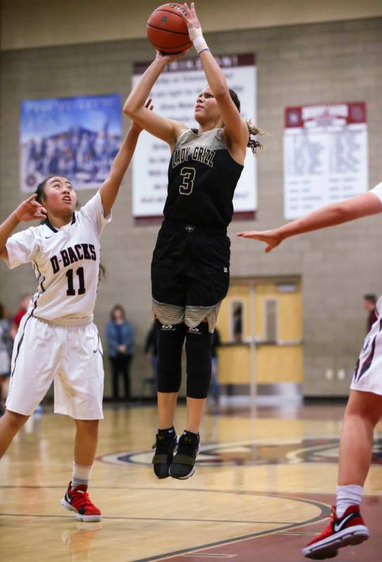 Spring Valley’s Essence Booker (3) shoots as Desert Oasis’ Kalena Halunajan (11) ...