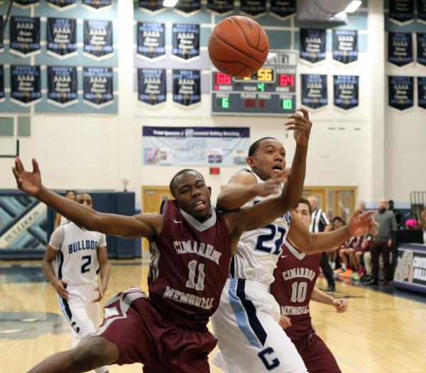 Cimarron-Memorial forward Tony Harrison (11) and Centennial forward Aaron Turner (22) battle ...