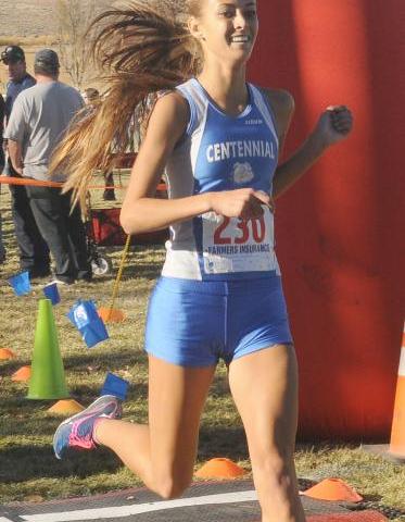 Sydney Badger of Centennial High School smiles as she crosses the finish line to win the Div ...