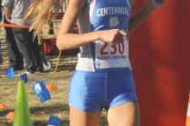 Sydney Badger of Centennial High School smiles as she crosses the finish line to win the Div ...