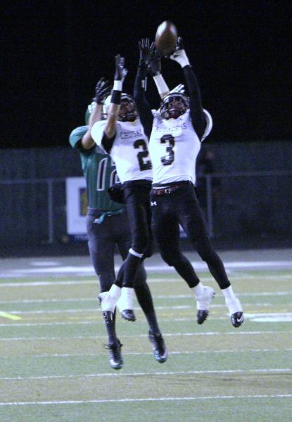 Faith Lutheran’s Vinny DeGeorge (3) gets help from teammate Mark Rubalcaba on an inter ...