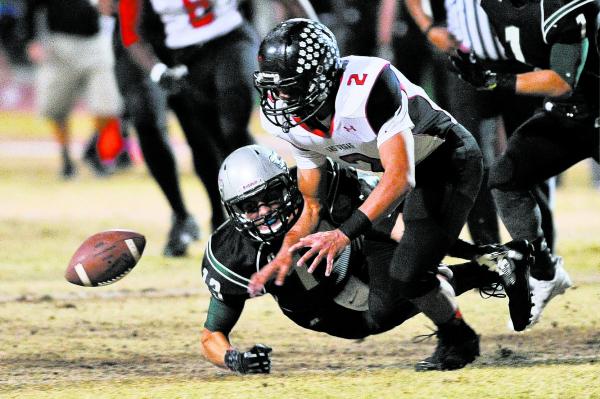 Las Vegas Jacob Littlefield (2) fights to recover a fumble by Green Valley’s Kyler Cha ...
