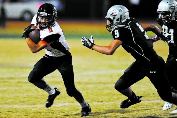 Las Vegas back Andrew Moreland (5) looks for running room against Green Valley’s Jairo ...