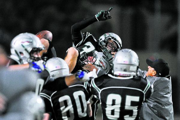 Green Valley’s Conor Perkins (33) is lifted up by his teammates after making a game-wi ...