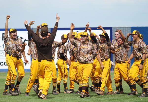 Bonanza baseball coach Derek Stafford, in the brown shirt, rushes to celebrate with his team ...