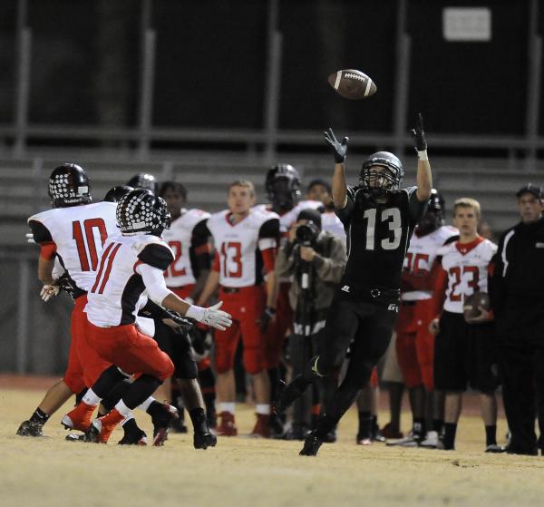 Green Valley’s Kyler Chavez (13) leaps to catch a tipped pass as Las Vegas’ Aaro ...