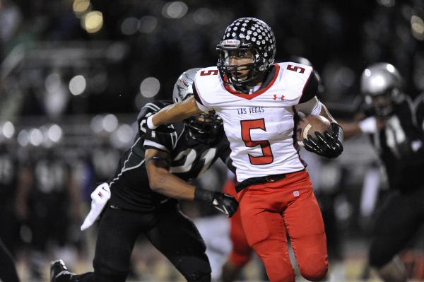 Las Vegas’ Andrew Moreland (5) carries the ball as Green Valley’s Larry Norman a ...