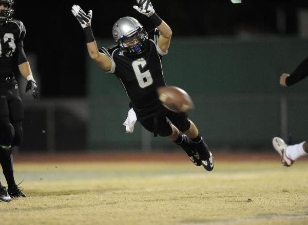 Green Valley’s Jacob Rivero leaps to try to block a point-after attempt.