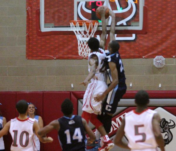 Arbor View’s Justin Burks, right, prevents a dunk by Centennial’s Troy Brown in ...