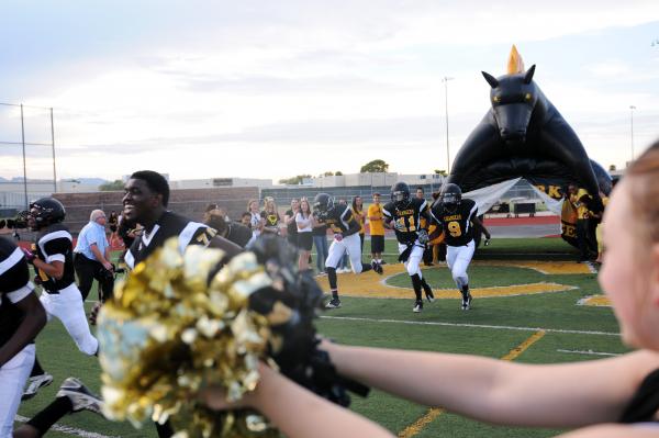 Clark players take the field prior to their home opener on Friday against Rancho.