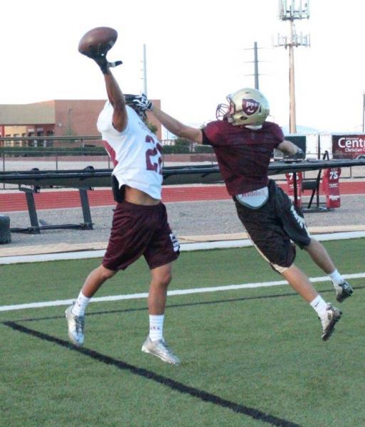 Keenan Smith, left, leaps to try to make a catch at a recent practice.