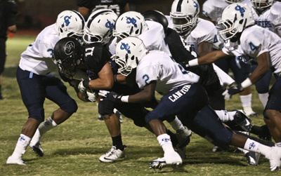 Palo Verde Panthers football player Andrew Simister (11) is tackled by Canyon Springs Pionee ...