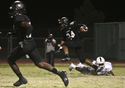 Palo Verde Panthers football player Ryan Beaulieu (24) sidesteps Canyon Springs Pioneers&#82 ...