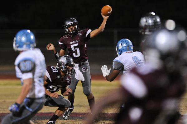 Cimarron’s Derek Morefield (5) looks to throw the ball Thursday against Centennial.