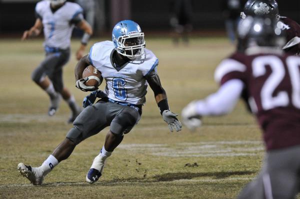 Centennial’s Lantz Worthington (6) looks for running room against Cimarron on Thursday ...