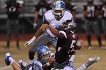 Cimarron’s Derek Morefield (5) loses the ball after being tackled by Centennial defend ...