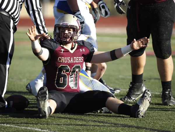 Matthew Chilman of Faith Lutheran celebrates after making a tackle on Saturday against Lowry ...