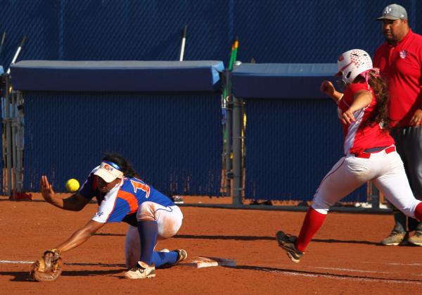 Bishop Gorman first baseman Jasmine Gibson can’t corral a wild throw as Arbor View&#82 ...
