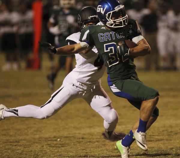 Green Valley’s Conor Perkins (33) gets taken down by Palo Verde’s Darrion Finn ( ...