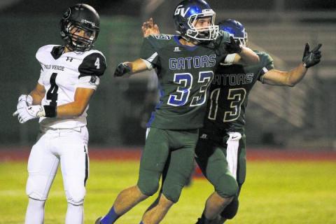 Green Valley kicker Conor Perkins (33) celebrates with  holder Kyler Chavez (13) after ...