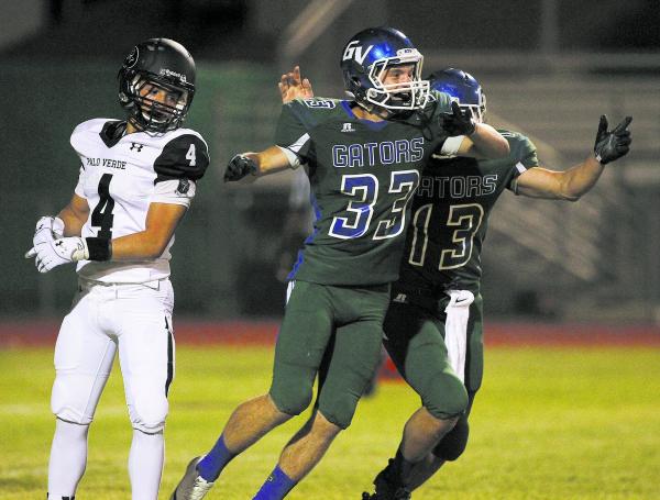 Green Valley kicker Conor Perkins (33) celebrates with holder Kyler Chavez (13) after ...