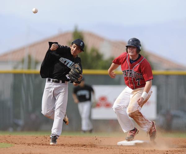 Silverado secodn baseman Alex Grafiada attempts to turn a double play in the second inning a ...