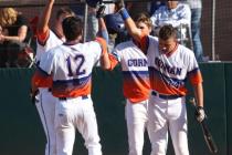 Kenny Meimerstorf (12) is greeted by Bishop Gorman teammates, from left, Nick Gates, Cole Kr ...