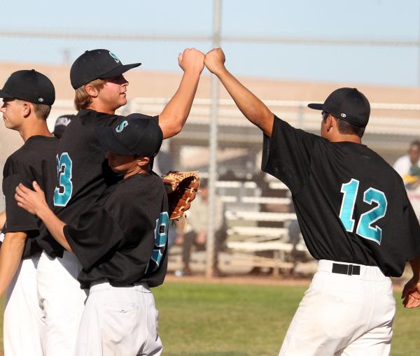 Silverado senior pitcher David Kuzma, left, fist-bumps senior teammate Thomas Licea after th ...