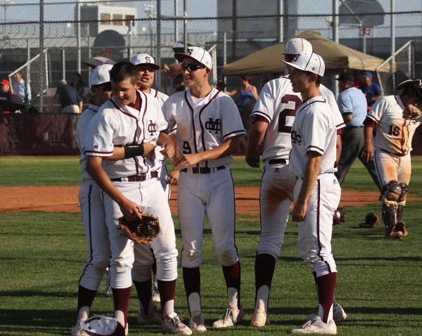 Cimarron-Memorial pitcher Larry Quaney, second from left, gets congratulated by his teammate ...