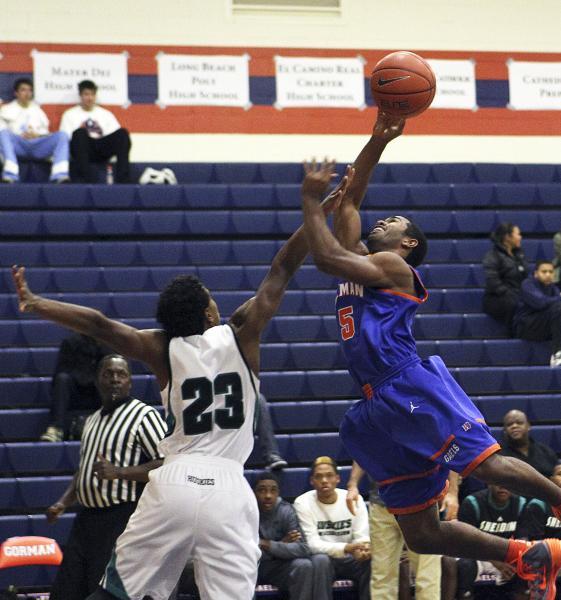 Gorman’s Miles Loupe (5) goes up for a shot while Sheldon’s Devin Greene (23) de ...