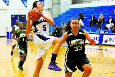 Durango basketball player Jazmin Chavez (5), center, goes in for a layup against Kianna Will ...