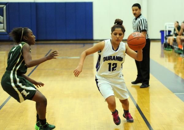 Durango basketball player Maria Rico (12), right, dribbles against Maia Crawley (1) of Lakes ...