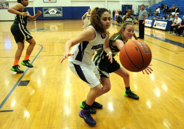 Durango basketball player Amanda Gutierrez (21), center, goes for a loose ball against Jayci ...