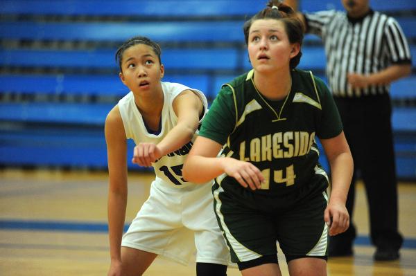 Durango basketball player Rianne Lu (15), left, battles for a rebound against Megan Wood (14 ...