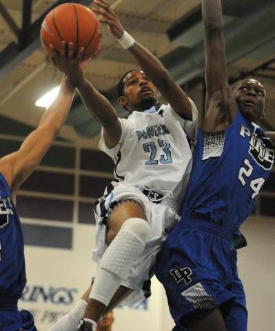 Canyon Springs guard Shaquile Carr (23) tries to score around Desert Pines forward ...