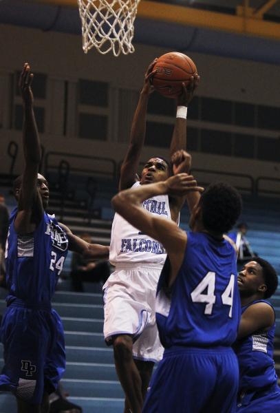 Foothill’s Jalen Shepard (1) shoots over Desert Pines’ Trevon Abdullah (44) and ...