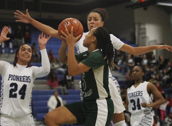 Canyon Springs’ Cherise Beynon (3) jumps in to block the shot of Rancho’s Kanosh ...