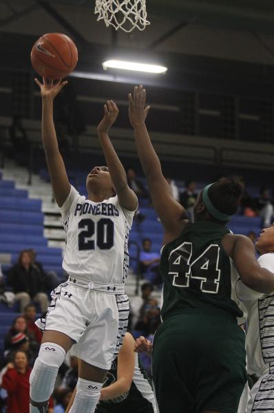 Canyon Springs’ Alexia Thrower (20) goes in for a layup past Rancho’s LaKissa Ma ...