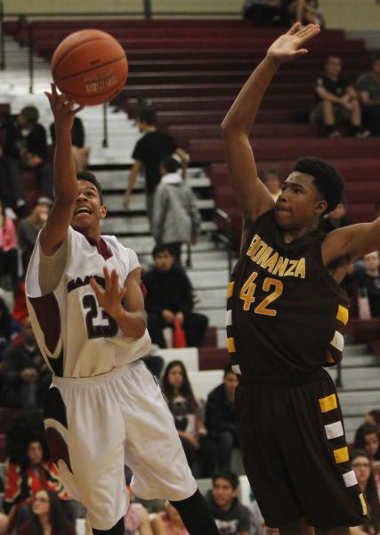 Desert Oasis’ Rodrick Moore (23) shoots past Bonanza’s Davian Jordan (42) on Fri ...