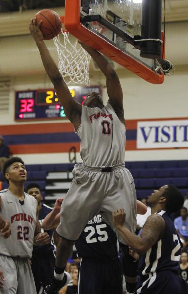 Findlay Prep’s Horace Spencer (0) grabs a rebound on Saturday against Impact Academy. ...