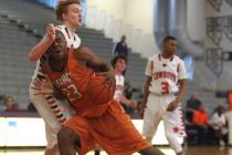 Legacy junior forward Deshaun Hilliard drives against Chaparral junior forward Josh Allen du ...