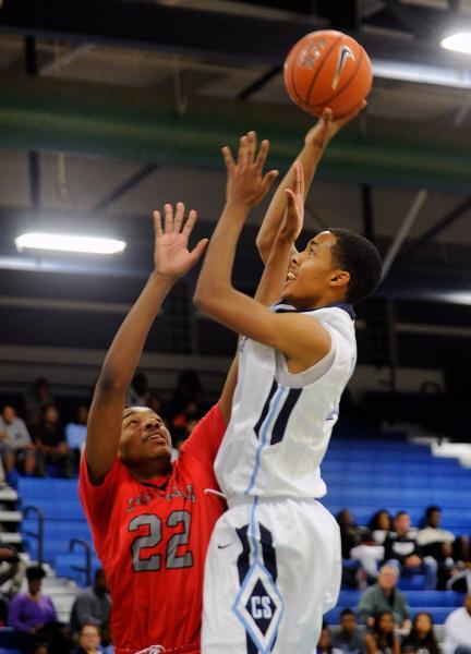 Canyon Springs’ Darrell McCall shoots over Las Vegas’ Patrick Savoy on Wednesday ...