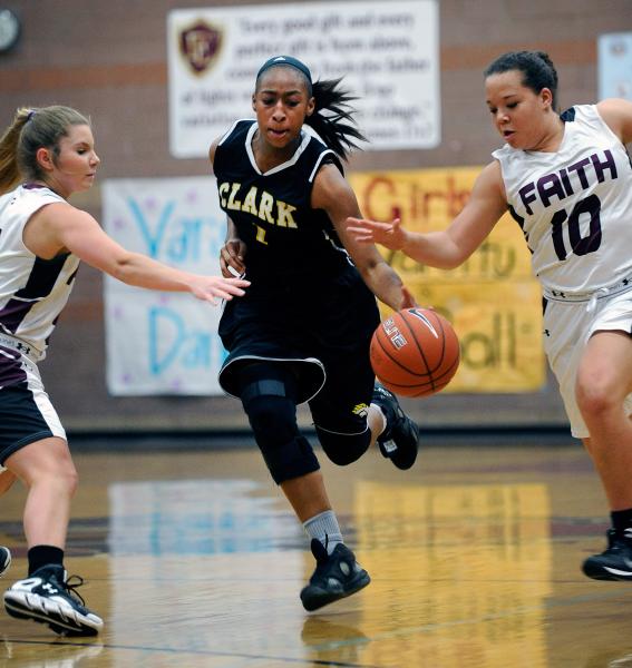 Clark’s Karlicia Stroughter drives the ball down court between Faith Lutheran’s ...