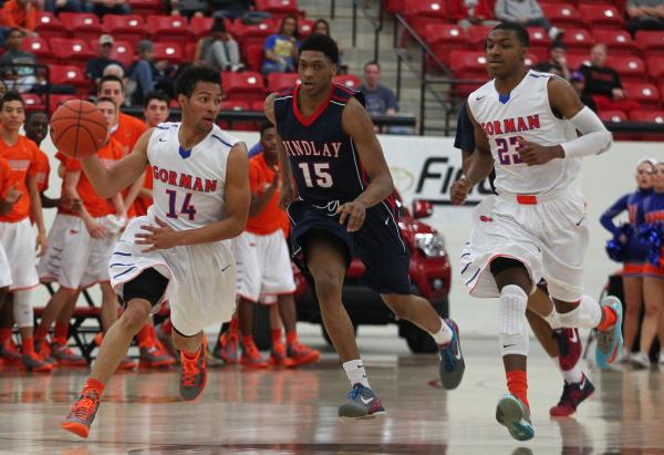 Bishop Gorman’s Noah Robotham (14) looks for help from teammate Nick Blair (23) as Fin ...