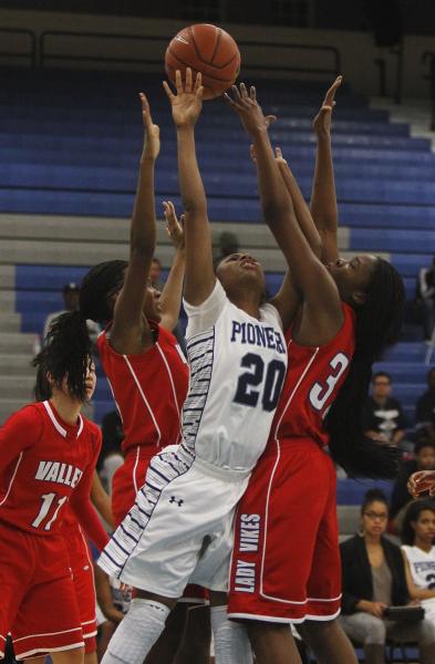 Canyon Springs’ Alexia Thrower (20) has her shot contested by Valley’s Eimainei ...