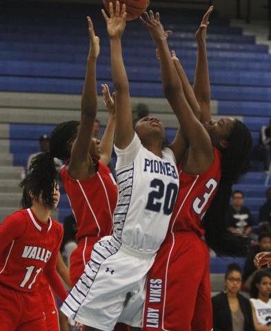 Canyon Springs’ Alexia Thrower (20) has her shot contested by Valley’s Eimainei ...