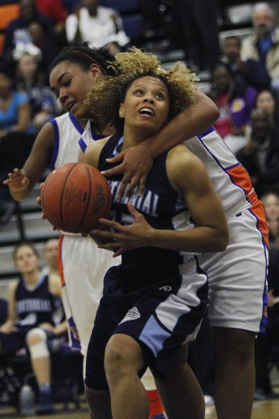 Centennial’s Teirra Hicks (22) gets fouled by Bishop Gorman’s Raychel Stanley (2 ...