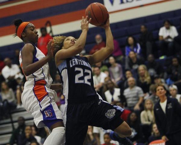 Centennial’s Teirra Hicks (22) drives to the hoop against Bishop Gorman’s Maddis ...