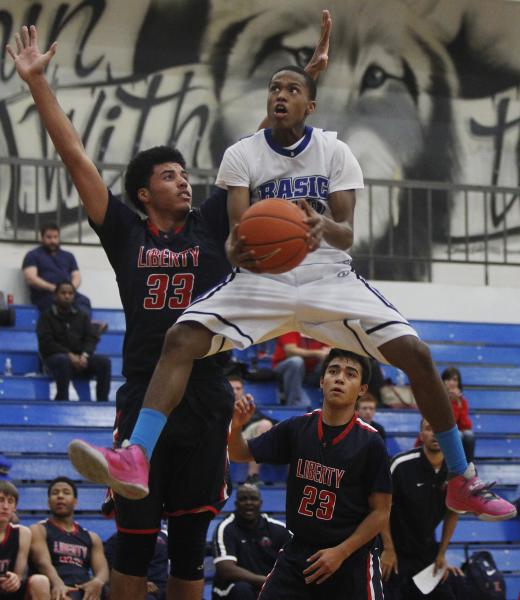 Basic’s Robert Sutton drives against Liberty’s Ed O’Bannon (33) during Thu ...