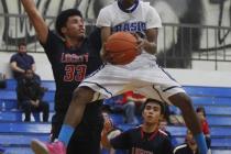 Basic’s Robert Sutton drives against Liberty’s Ed O’Bannon (33) during Thu ...